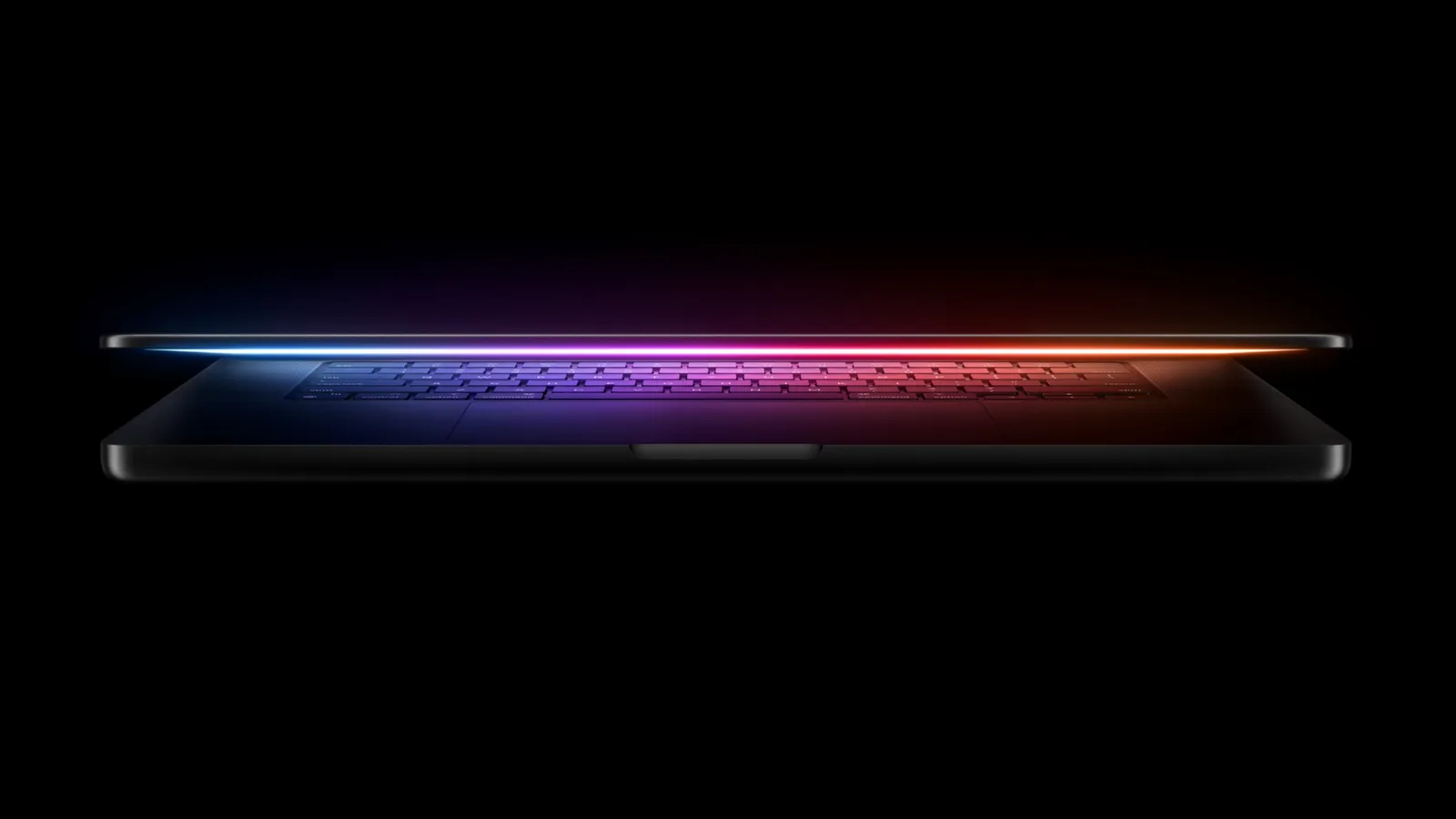 A MacBook Pro with a thin OLED display and Dynamic Island cutout on a desk